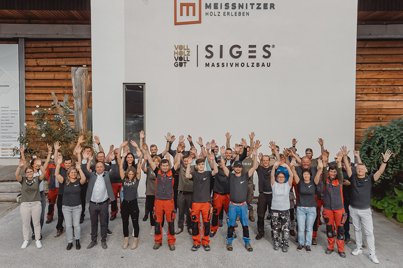 Mitarbeiterinnen und Mitarbeiter von SIGES und Holz Meissnitzer vor dem Firmengebäude in Niedernsill.