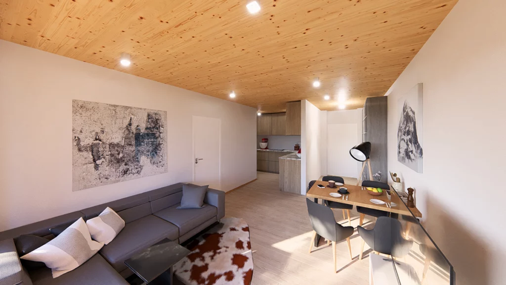 Innenansicht einer Wohnung im Projekt Piesendorf mit Holzsichtdecke und Sicht auf die Wohn- Essküche